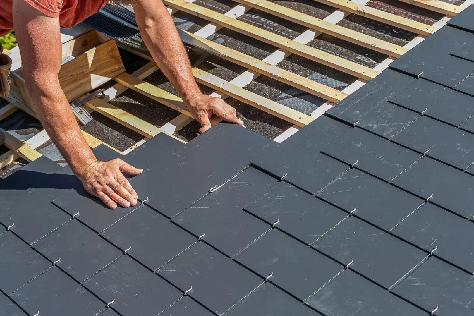Craftsmen are installing a slate roof home.