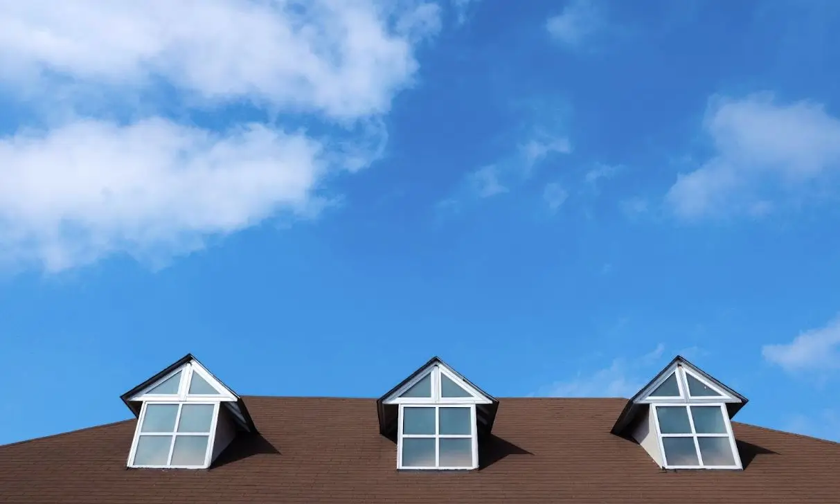 Residential roofing with open sky in the background.