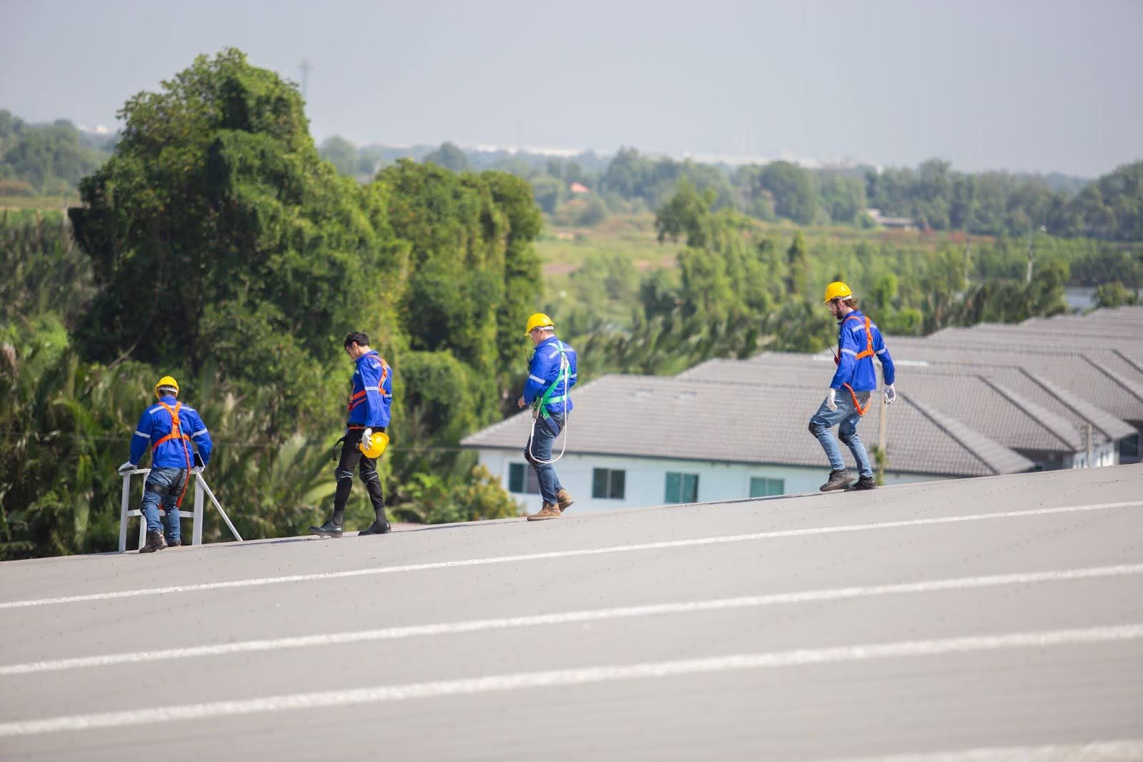 Roofing contractor inspecting roof installation for quality standards