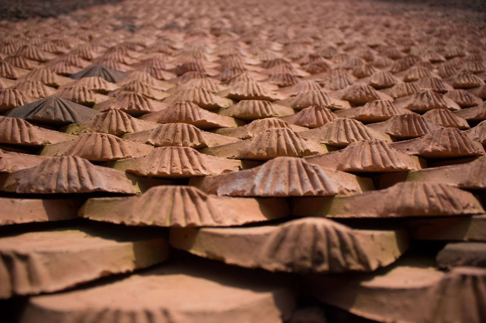 An extreme closeup on a home’s brown roofing tile.