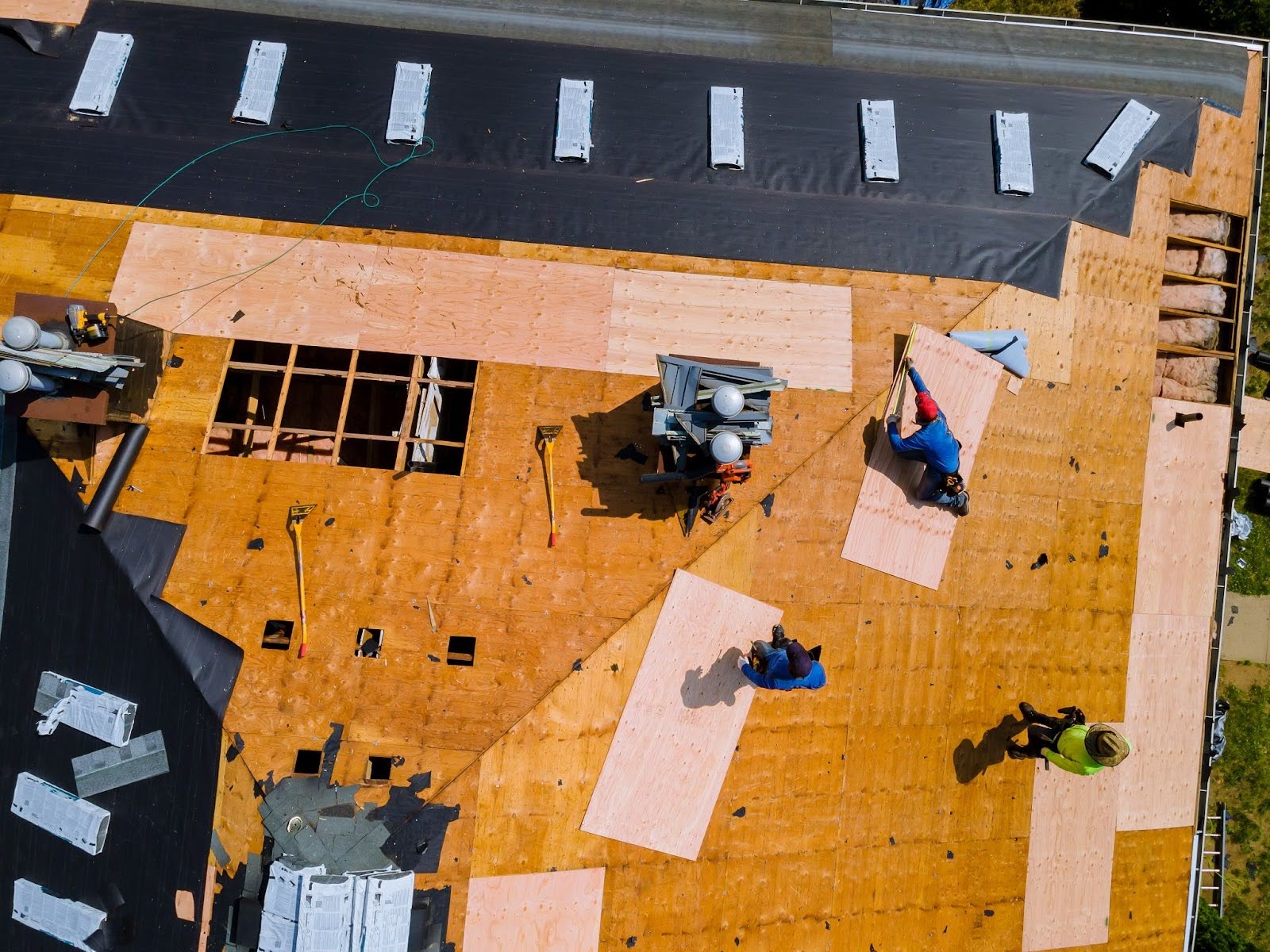 An overview of a construction crew working on a roof.
