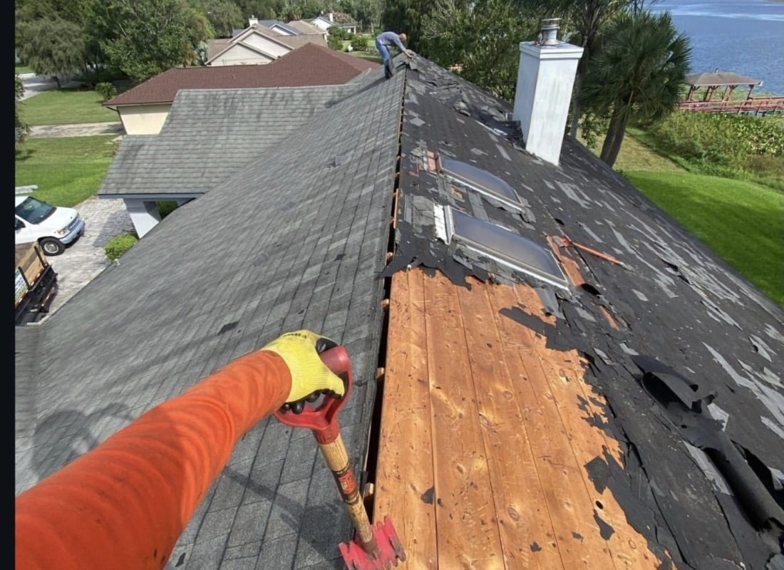 Roof tear-off exposing wood decking during replacement by Febres Roofing