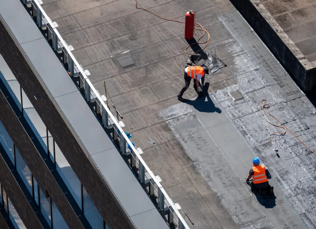 Professional bitumen waterproofing on a flat building.